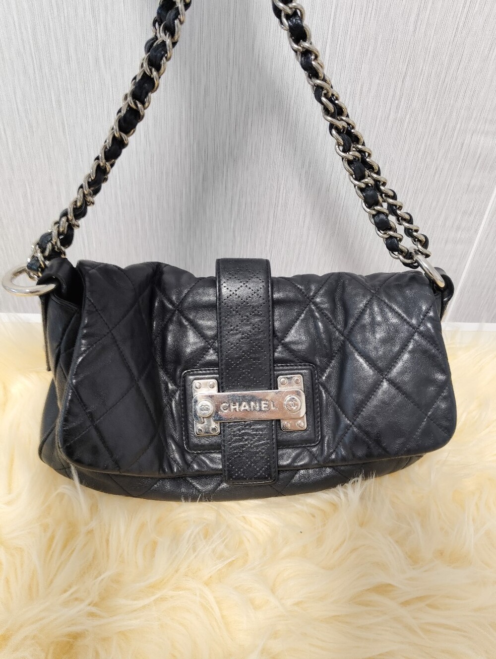 CHANEL Black Quilted Leather Shoulder Bag with Metal Plaque